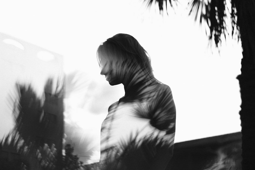 Creative double-exposure portrait photography by Houston photographer - woman superimposed over palm fronds